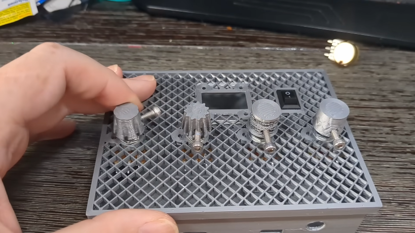 Dense layout of small custom knobs secured with M3 screws on a synthesizer panel.